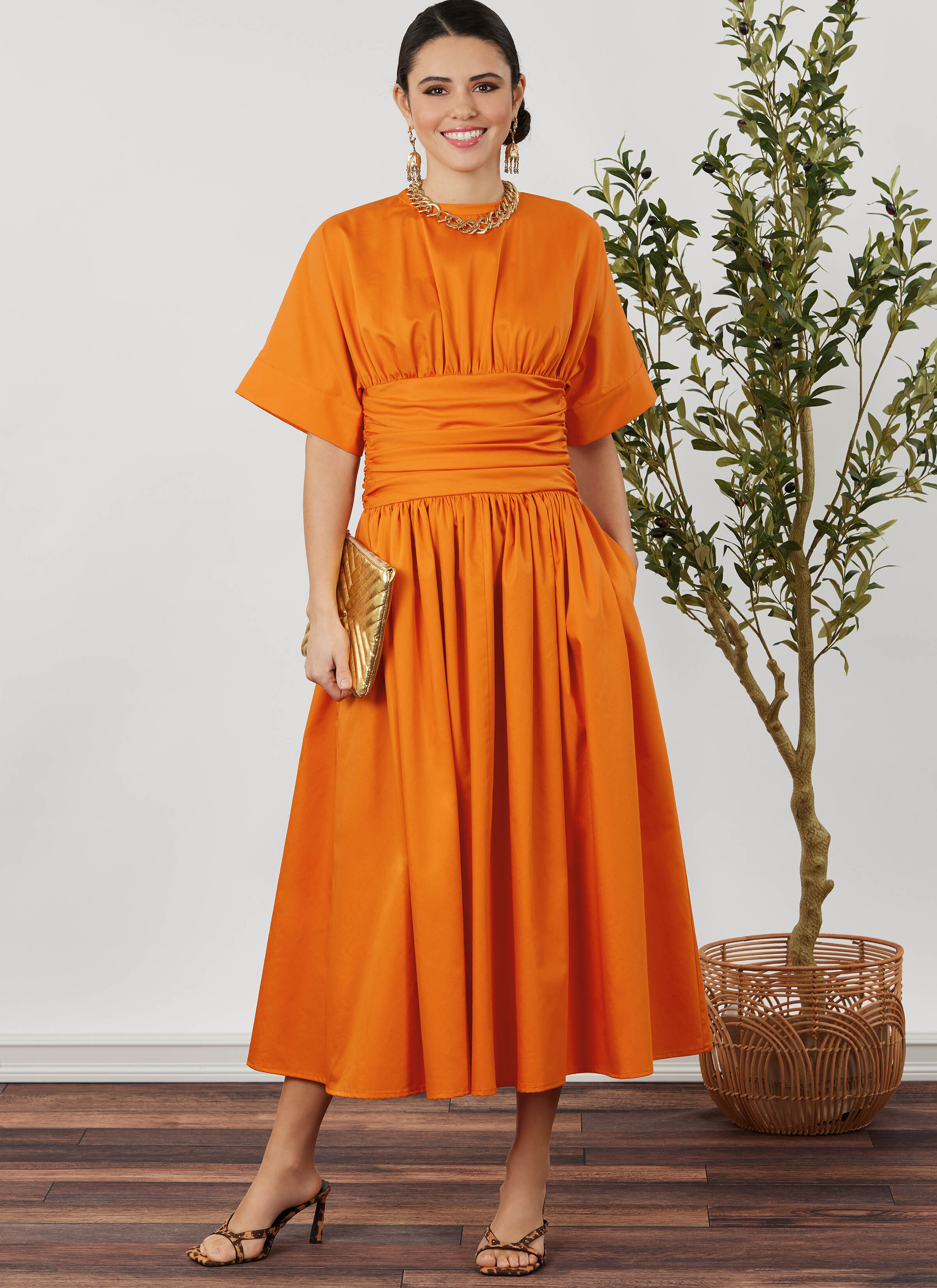 Woman wearing orange dress with cinched waist